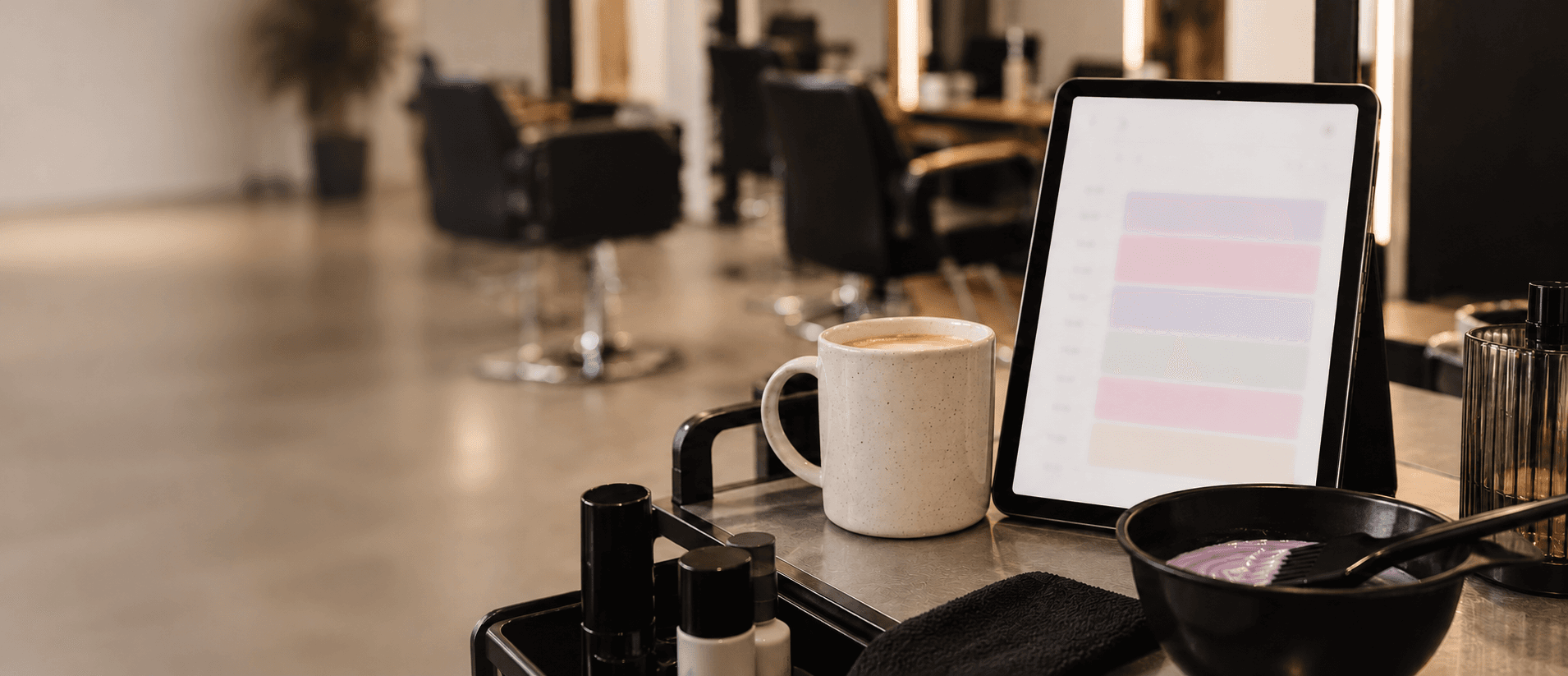 Tablet with a calendar and a colour-mixing bowl on a salon counter.